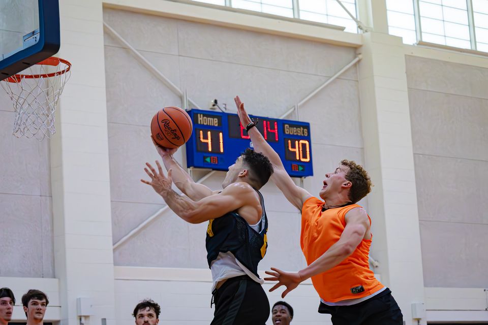 A WVU Club Basketball team member drives to the basket in an attempt for a layup in a tournament game at the WVU Student Rec Center.
